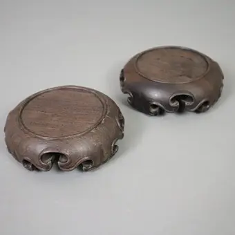 A PAIR OF ROUND CHINESE WOODEN STANDS.