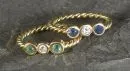 Ladies' rings, 2 pieces – 750 yellow gold, approx. 3.5 g total, twisted band, with diamonds, sapphire and emerald, size 47