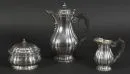 Coffee set, 3 pieces "Bossard, Luzern" – 875 silver, 1379 g total, wavy wall, coffee pot and milk jug with baluster body and ebonized wood handles, oval sugar box, H= 11-24 cm, circa 1900