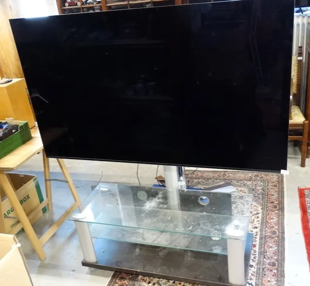1 grote televisie en 1 glazen tv-tafel