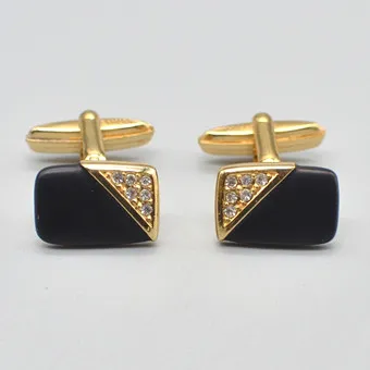 CHRISTIAN DIOR. DESIGNER CUFFLINKS, ONYX, RHINESTONES, GILT SETTING, CIRCA 1950, WITH ORIGINAL PACKAGING.