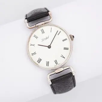 Vintage armbåndsur af mærket Symbol, »Swiss Made«, sort læderrem, manuelt optræk.