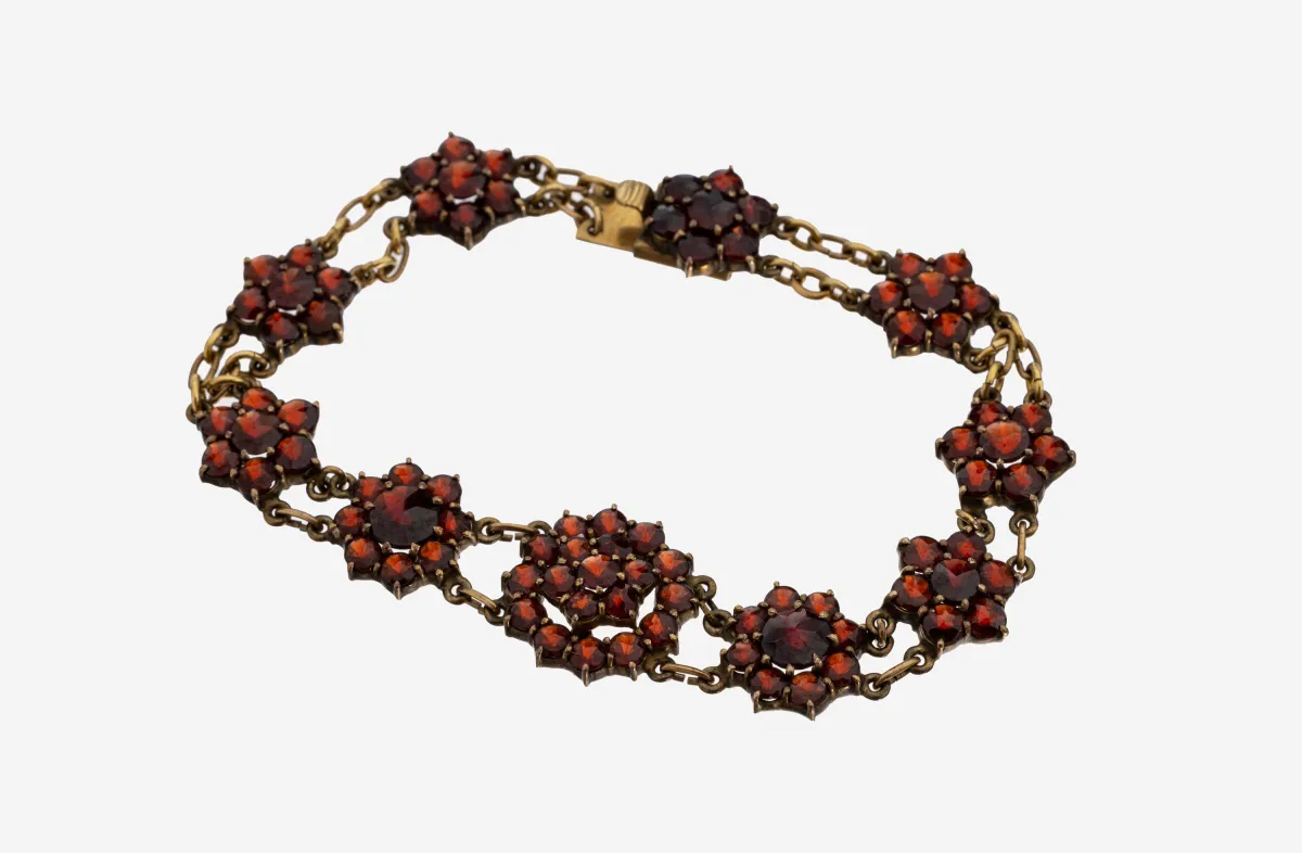 8 kt Gold Granat-Armband, GG 333/000, blütenf. Elemente mit rundfacett. Granaten,