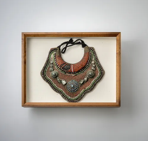 Brustschmuck mit Stein- und Perlenbesatz, ein weiterer Brustschmuck und zwei Ketten, in Glaskästen montiert