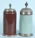 Cylindrical jugs, 2 pieces – Faience, light green/brown glaze, base rings and pewter lids, H= 22/24 cm, 18th/19th c., 1 with glaze cracks;