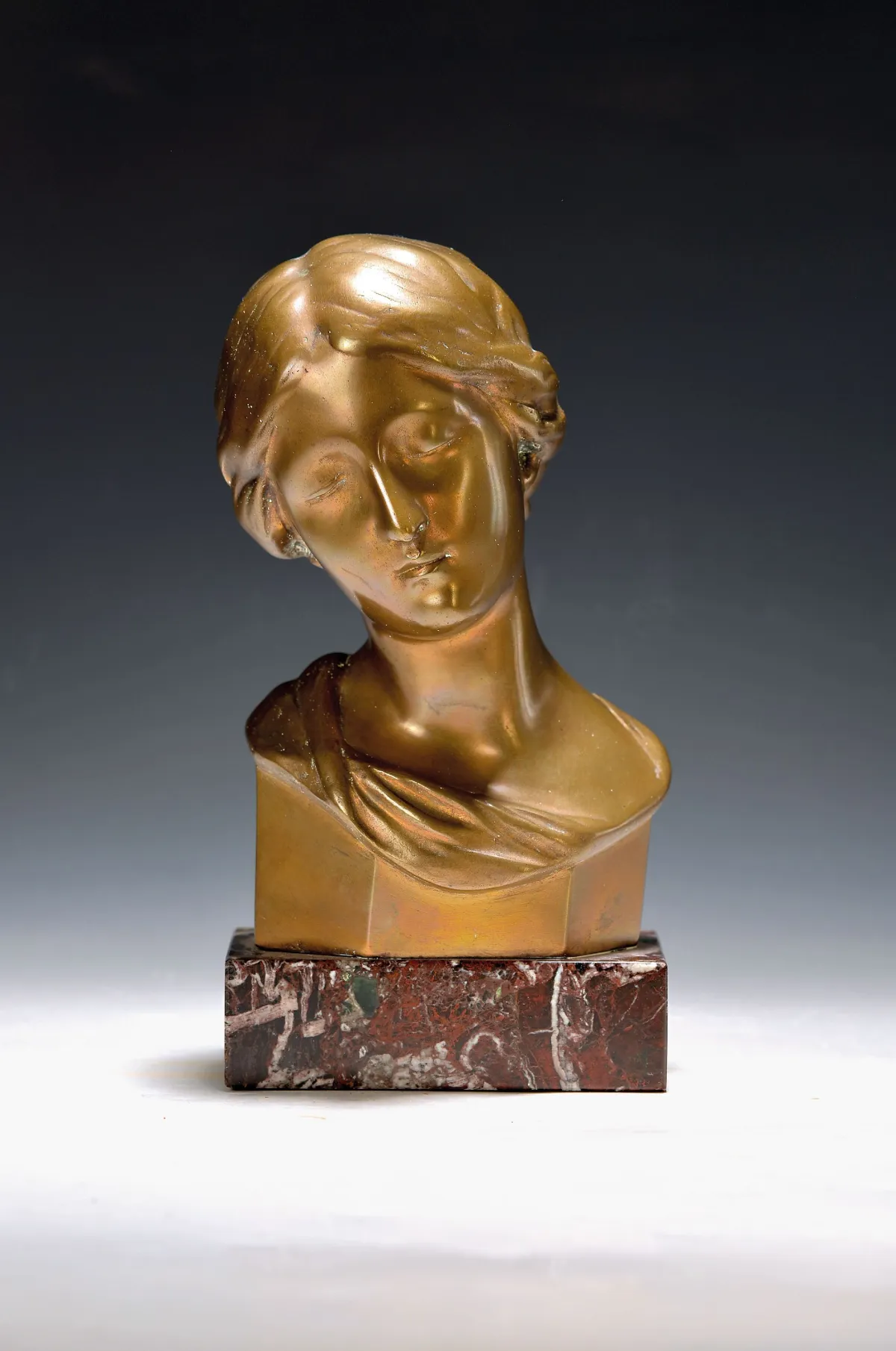 Vrouwenbuste, circa 1900, brons, achterzijde gemonogrammeerd GL, op marmeren sokkel, ca. 23 cm