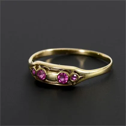 Delicate Art Nouveau ring with small red stones or synthetics