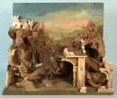 Christmas nativity – wood/bark pieces, painted fibreboard back wall, shaped as rocky terrain with ruins, 61 x 71 x 30 cm, without figures