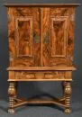 Cabinet – walnut, base: 4 turned legs with cross braces, top: 2 doors and sides with profiled panels, 9 drawers inside