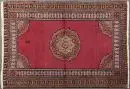 Chorrasan, Perse, 114 x 165 cm – antique, laine, colorants végétaux, fond rouge, médaillon multicolore, plusieurs bordures, traces d'usure