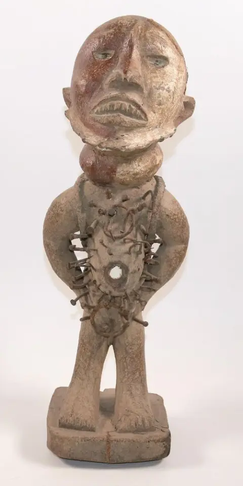 Nkisi Kongo nail fetish. – Male figure with thick belly and