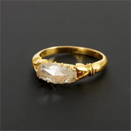 Unusual ring with slightly pear-shaped diamond