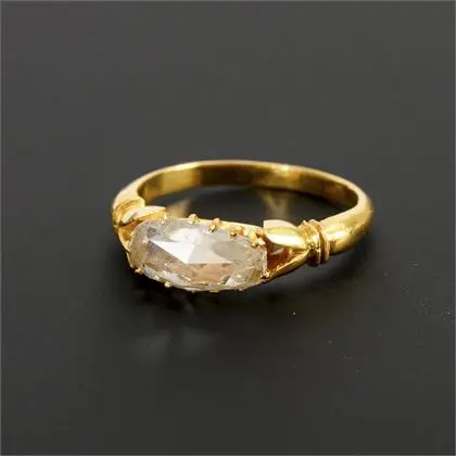 Unusual ring with slightly pear-shaped diamond
