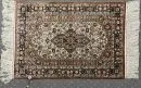 Seiden-Hereke, China, 63 x 91 cm – on silk, very finely knotted, light background, elongated central medallion, surrounded by floral motifs, dark blue main border