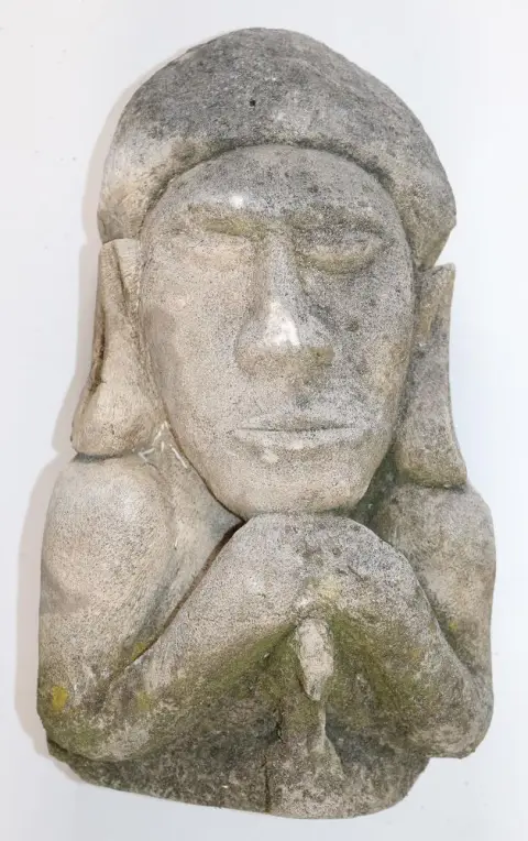 Indonesia stone sculpture. – Sculptural figure with elongated ears and