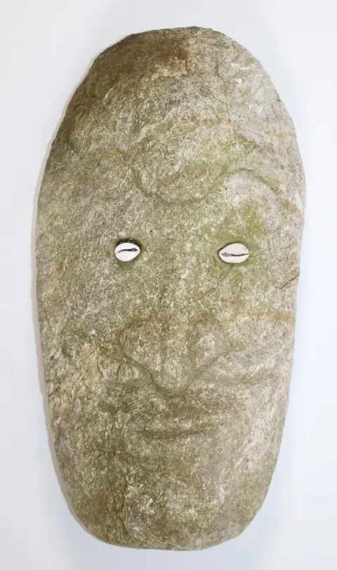 Stone head – male ancestral face probably of volcanic rock