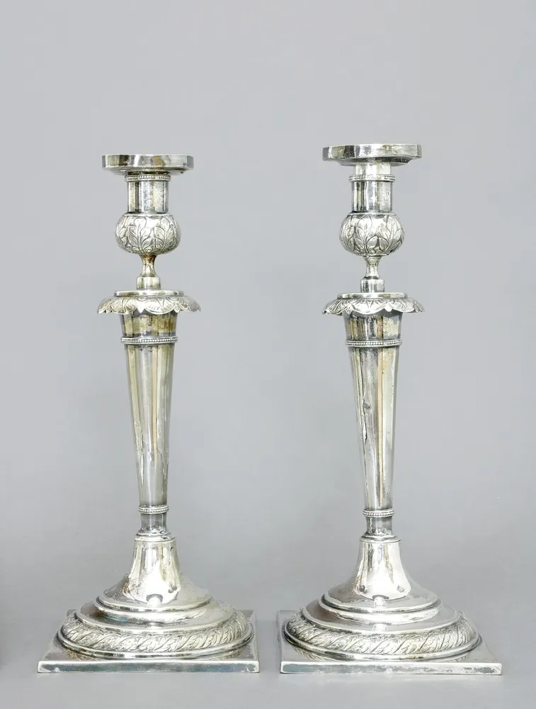 Candlesticks, 12 lot, German, 1st half 19th c., a pair, square base with round rising foot and surrounding leaf relief