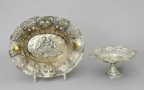 Schalen, 800 zilver, Duits, waarschijnlijk Hanau, 2 stuks 1. Opengewerkte schaal, ovaal, met putti en rozendecor, 6,5 x 25,2 x 20,8 cm. Gewicht…