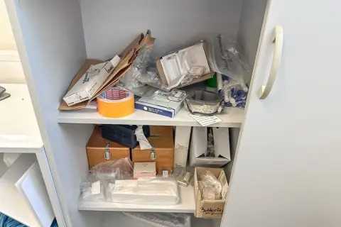 Contents of 2 shelf levels: laboratory supplies