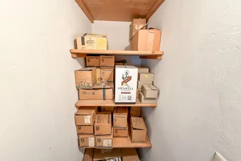 Contents of 3 shelf levels: glasses, boxes partially opened
